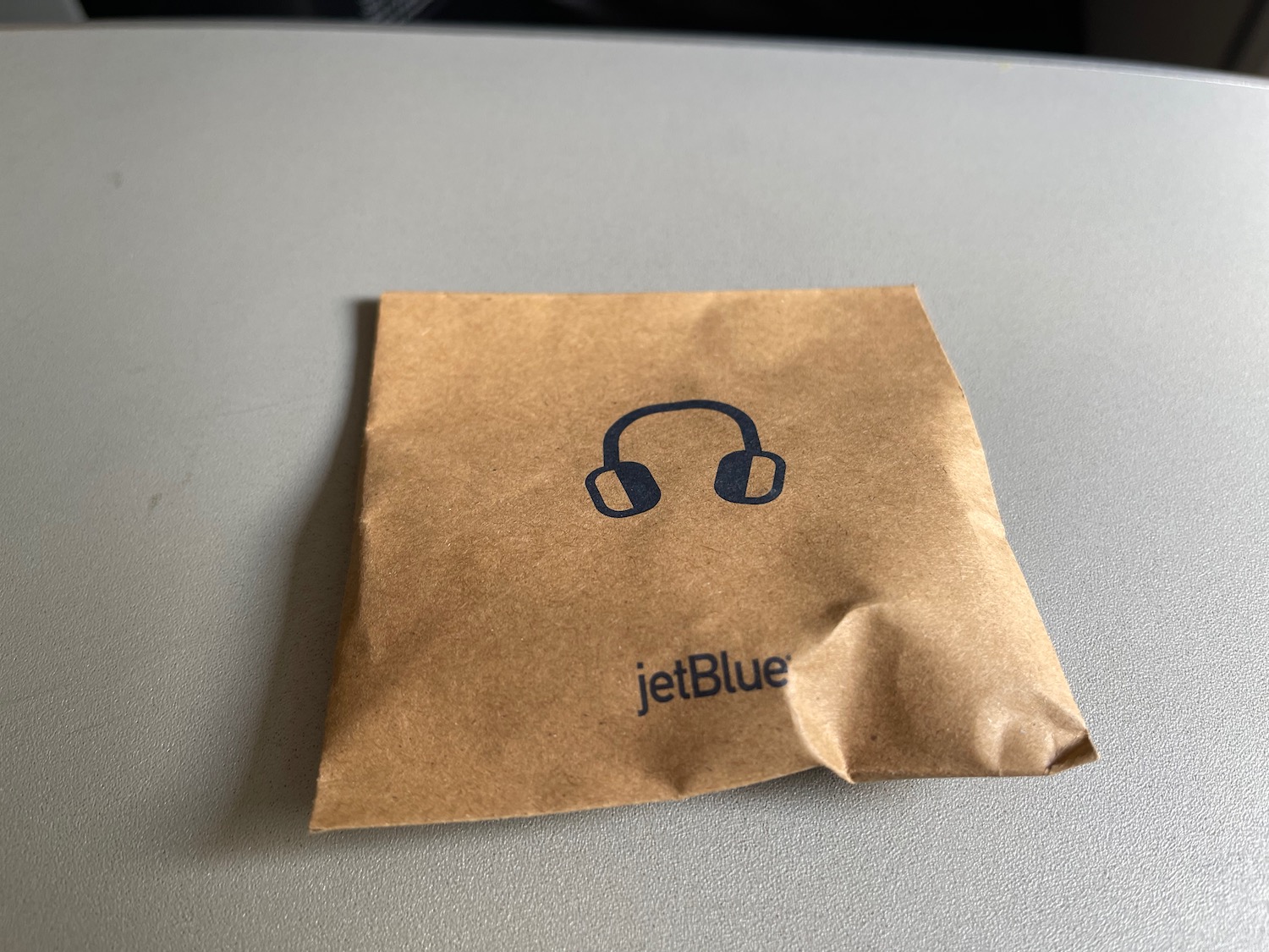 a brown paper bag with headphones on it