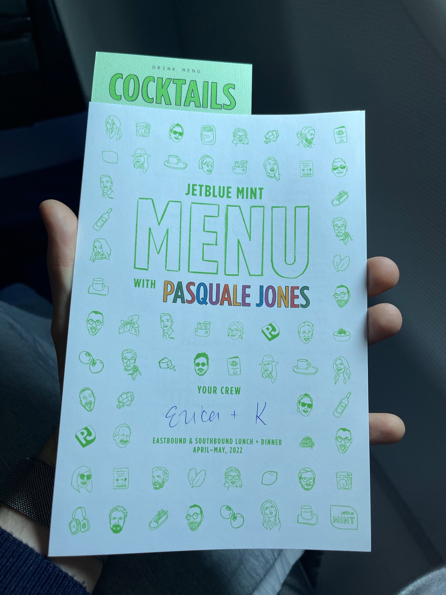 a hand holding a menu