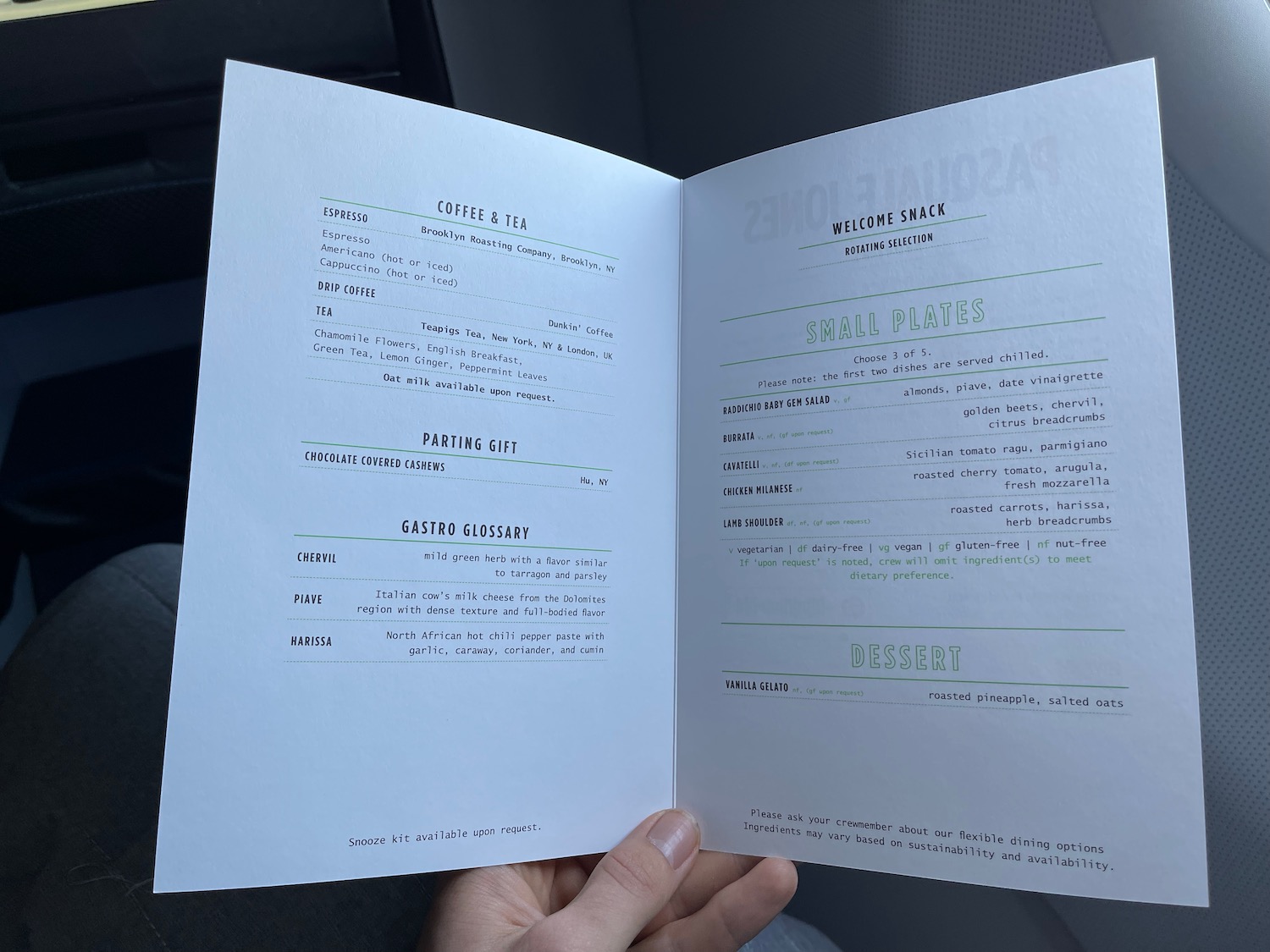 a hand holding a menu