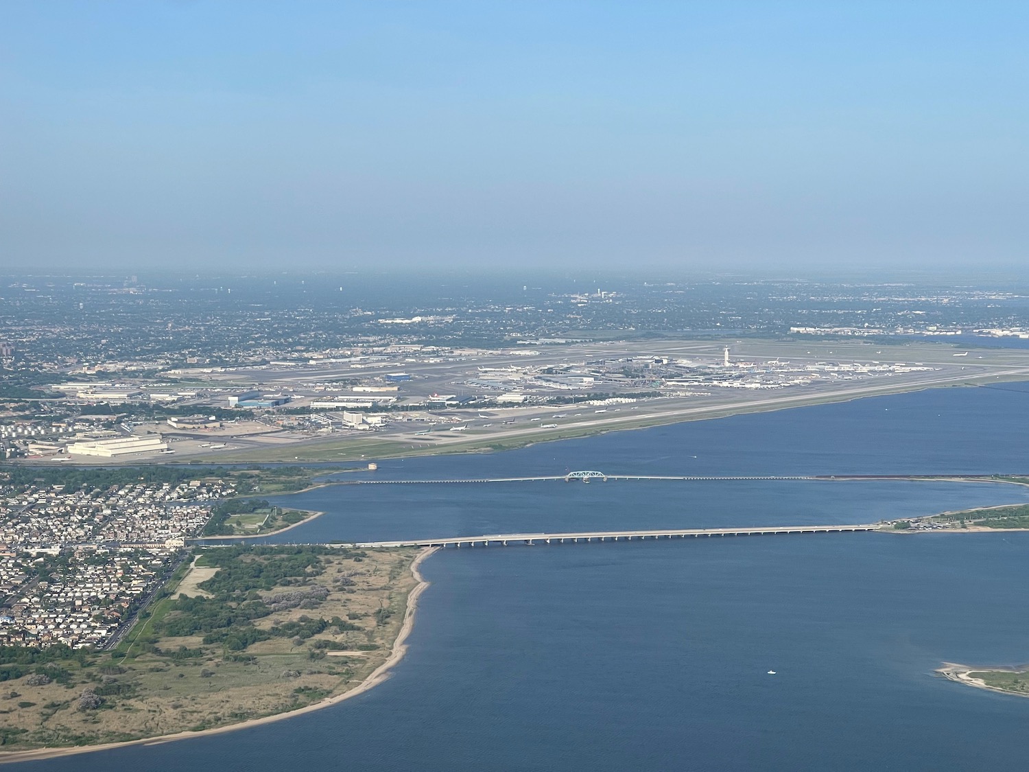 a body of water with a bridge and land and buildings