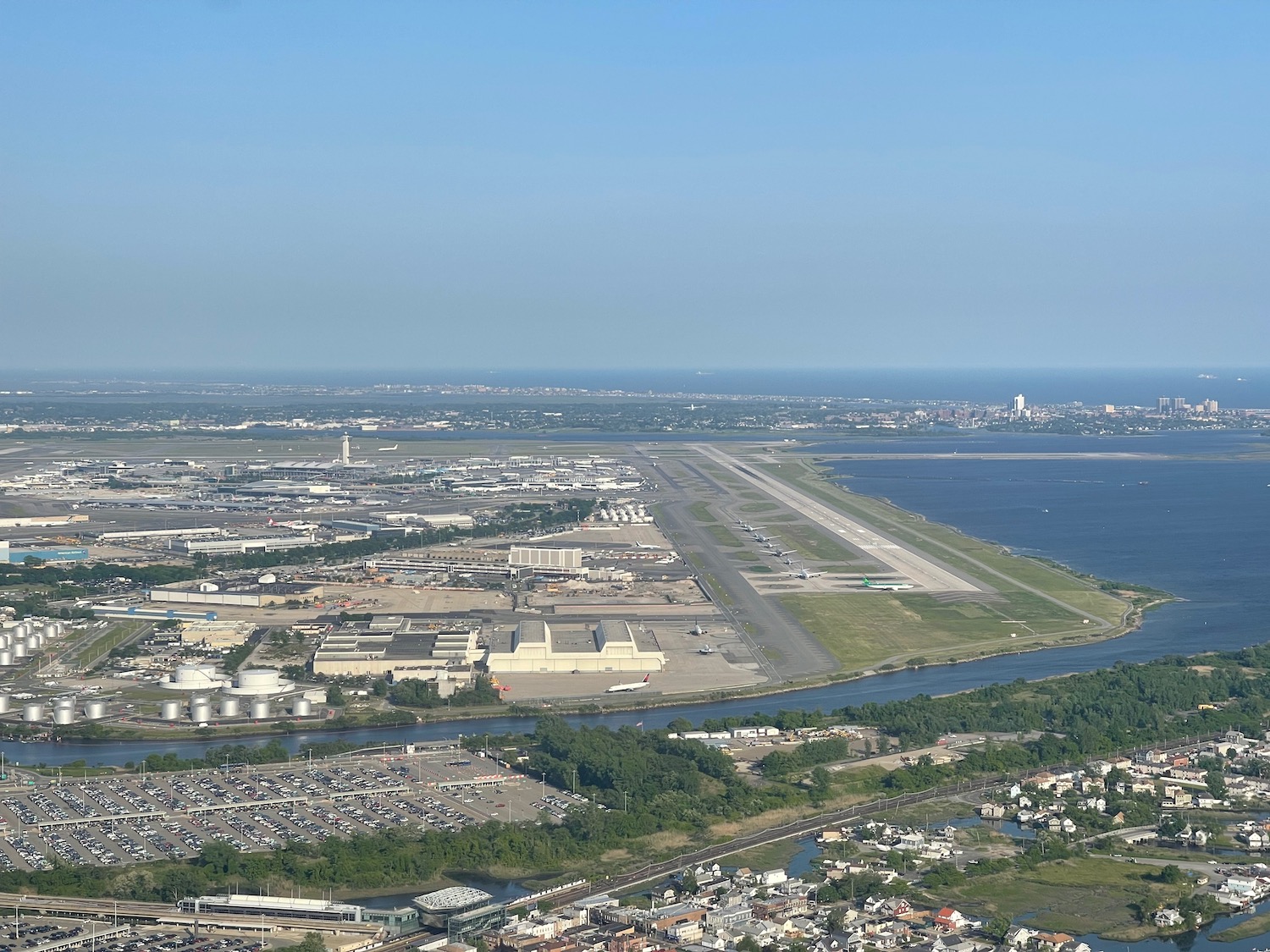 an aerial view of a runway and a body of water