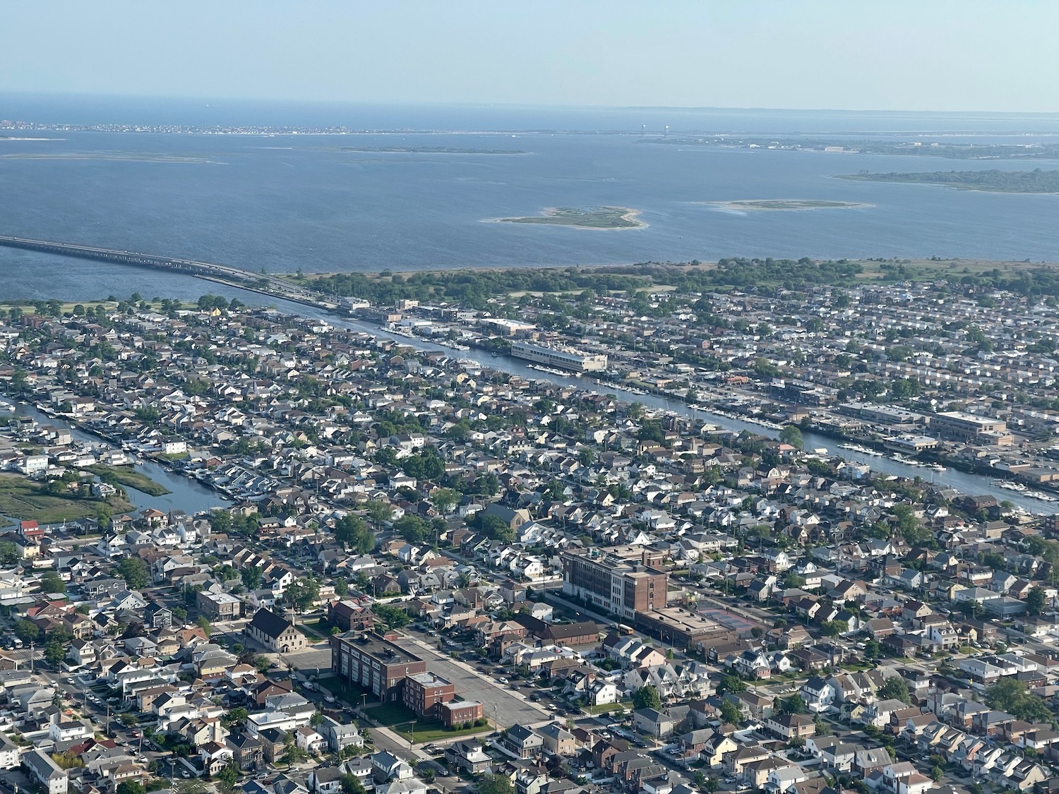 aerial view of a city with a river and a body of water