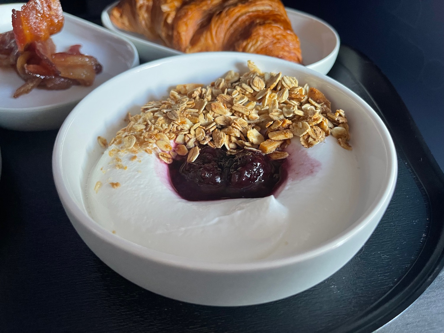 a bowl of yogurt with oat flakes and jam