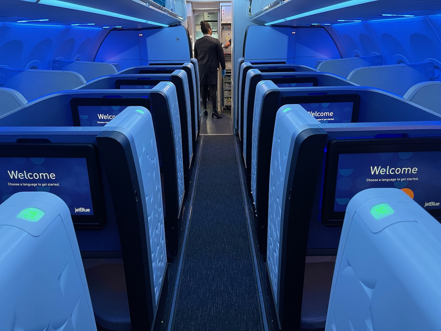 a man standing in a row of blue chairs