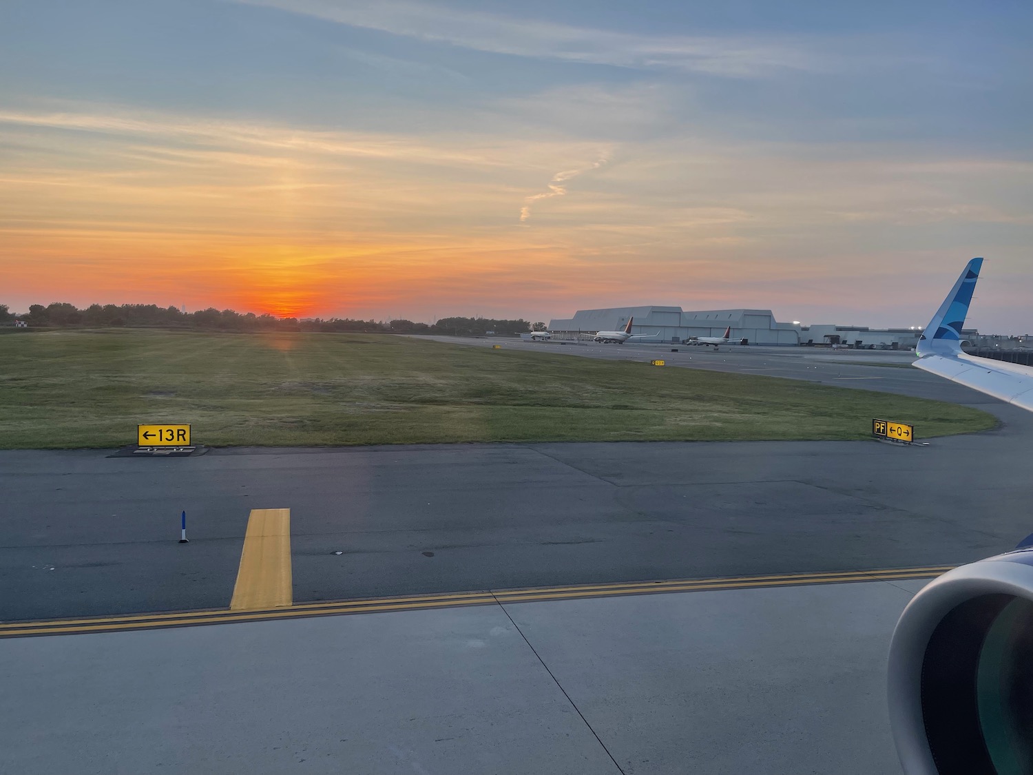 an airport with a sunset in the background