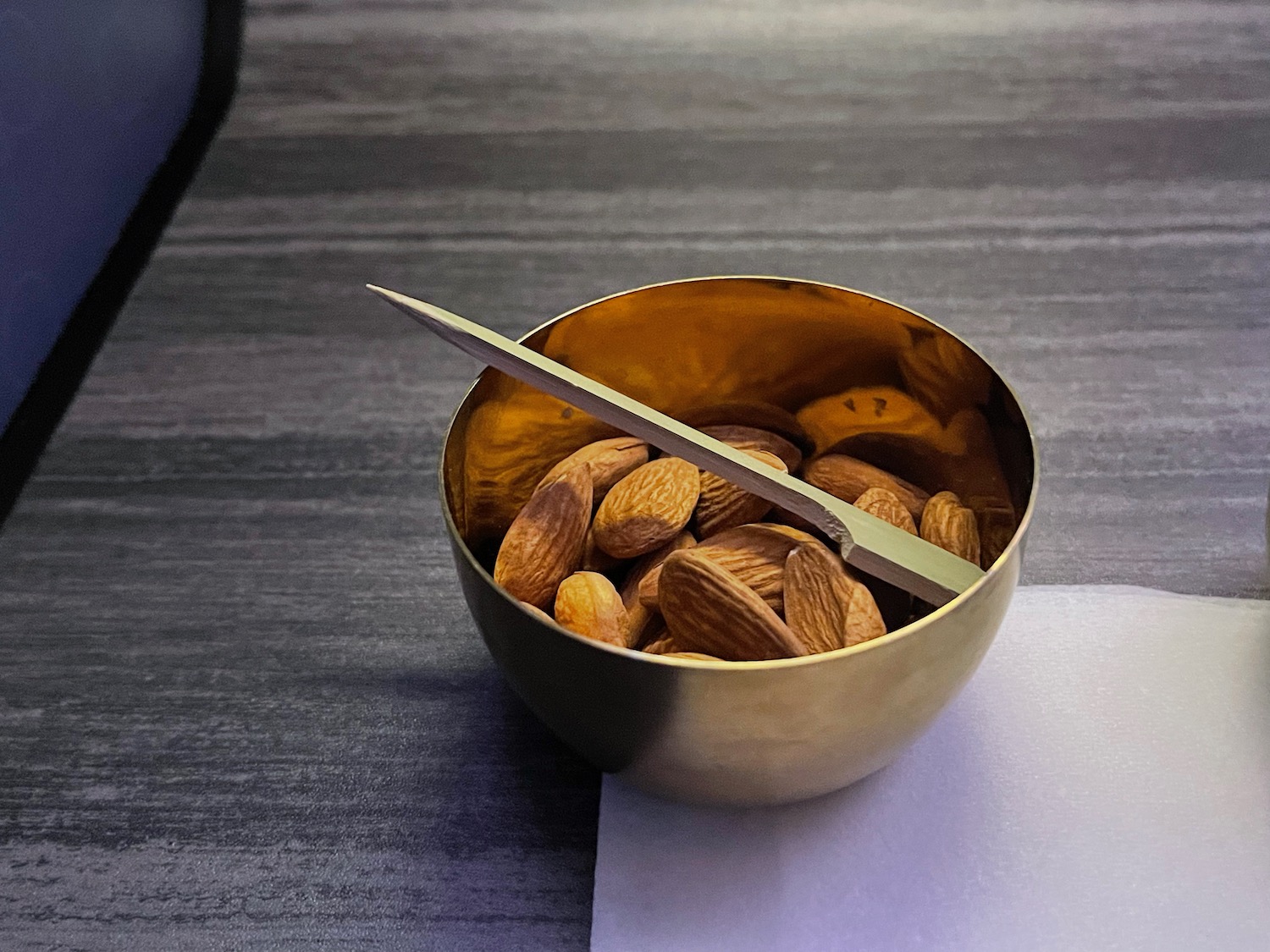 a bowl of nuts and a knife