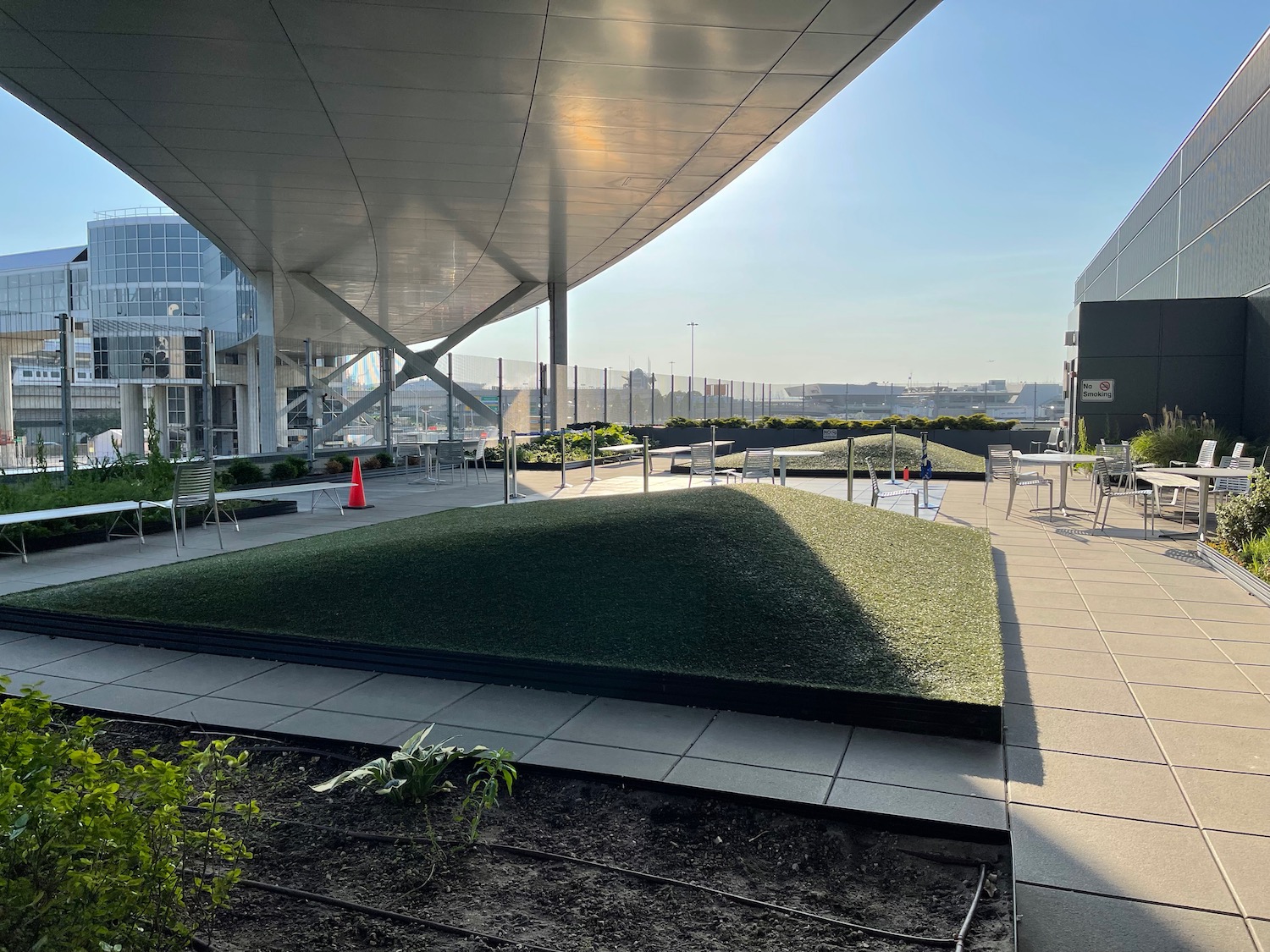 a building with a green lawn and chairs