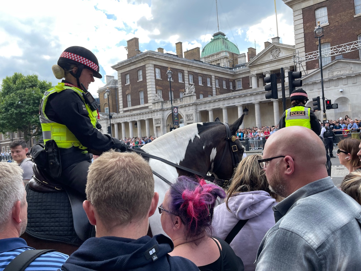 a police officer on a horse in front of a crowd
