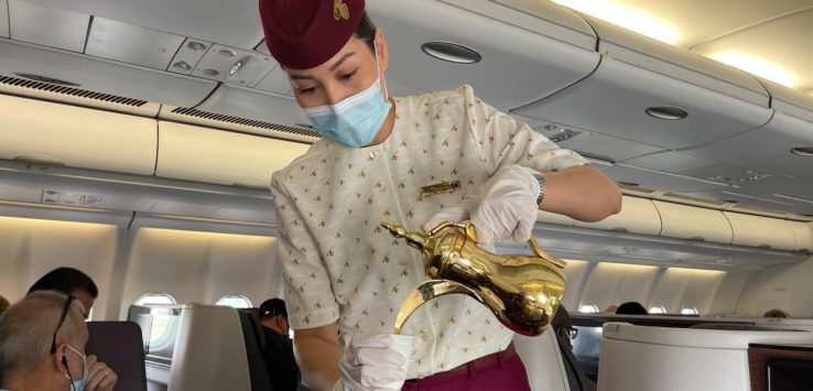 a woman wearing a mask and gloves holding a gold object