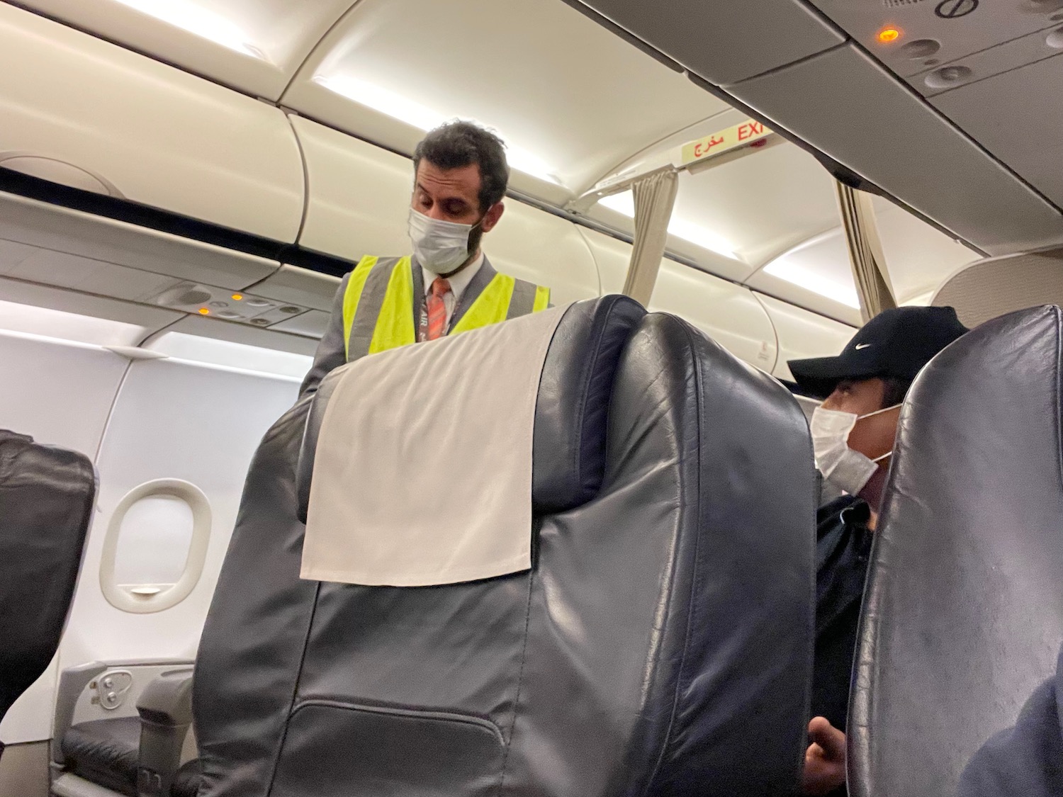 a man wearing a mask and standing in a plane