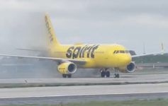 a yellow airplane on a runway