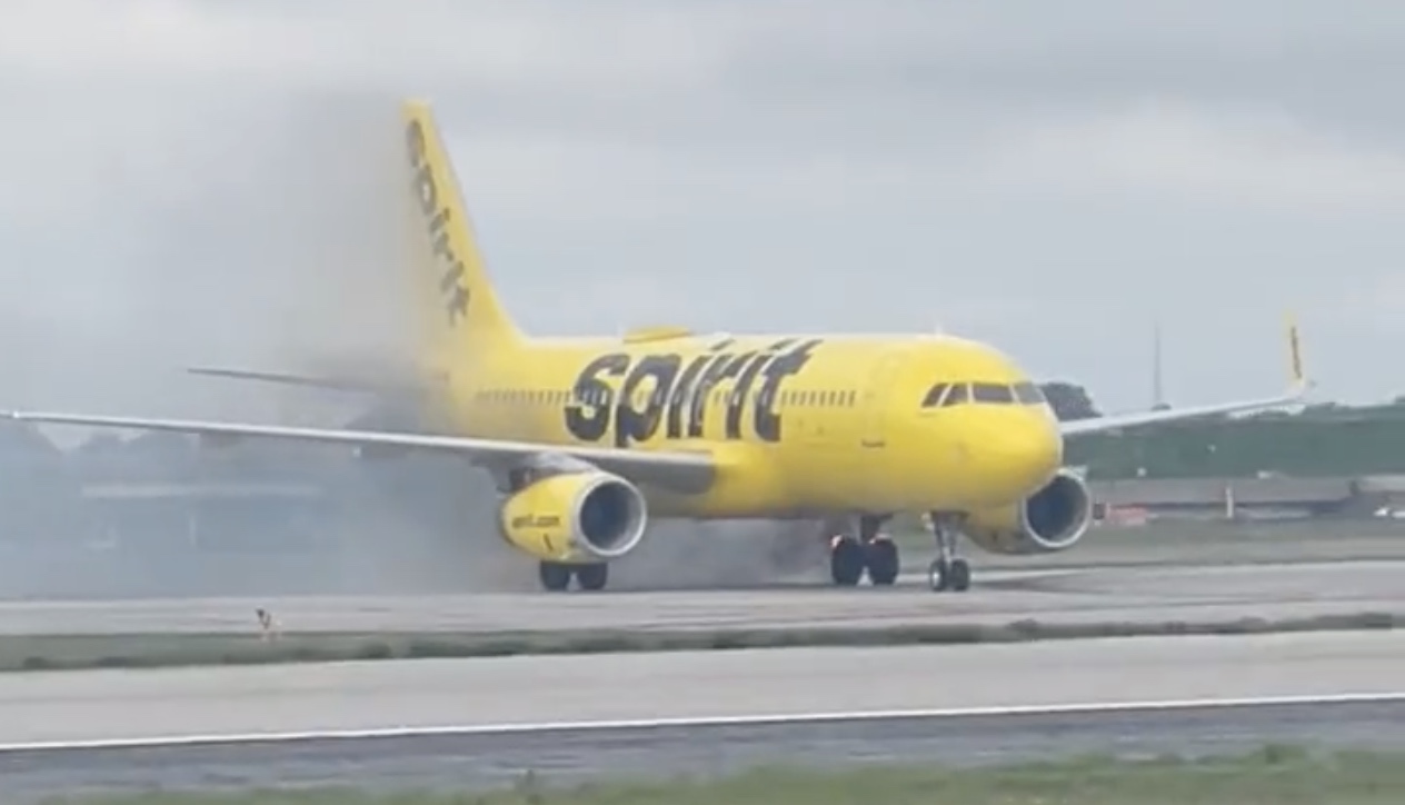 a yellow airplane on a runway