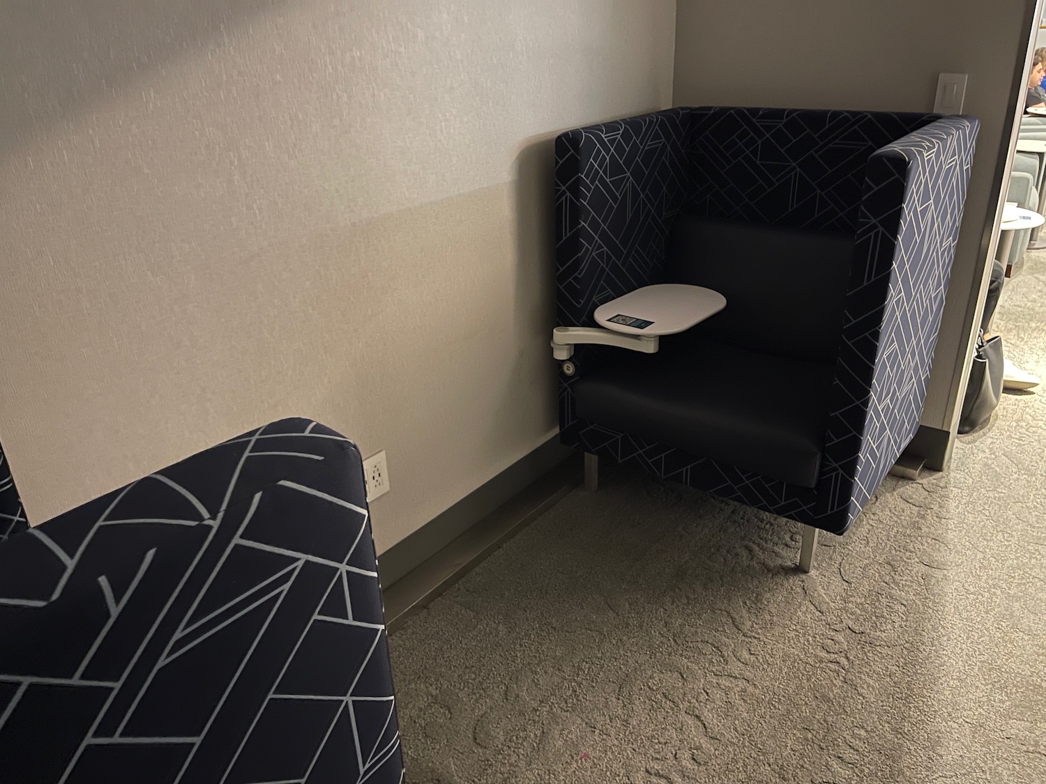 a chair with a table in the corner of a room