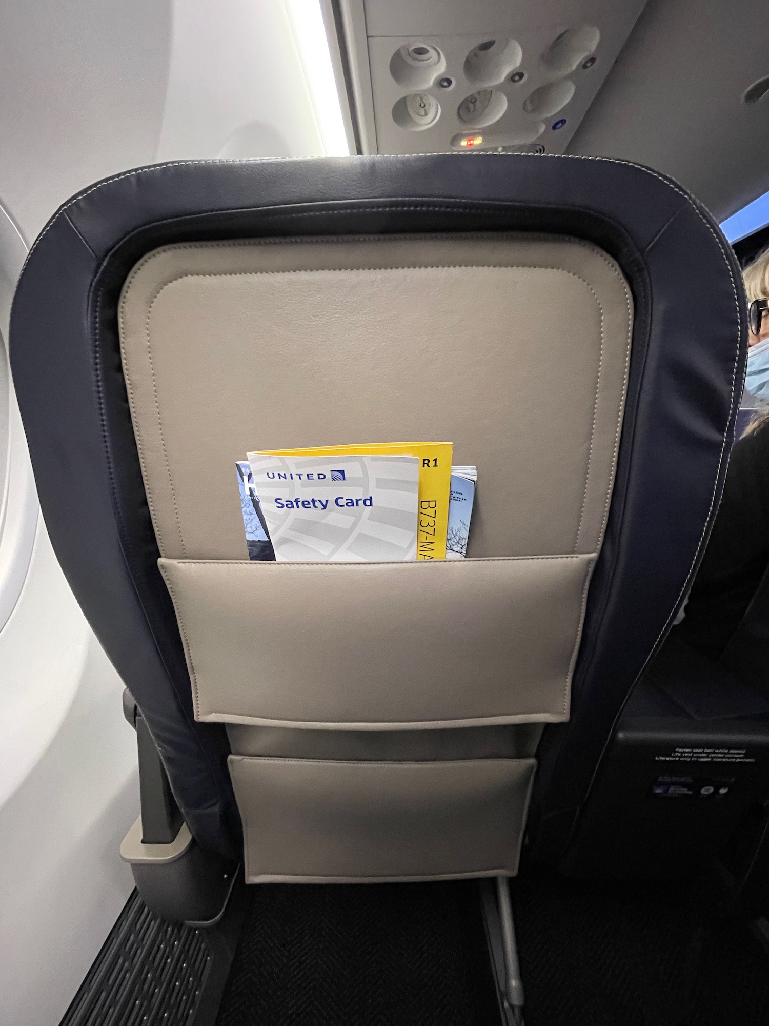 a seat with a seat pocket and a card in it