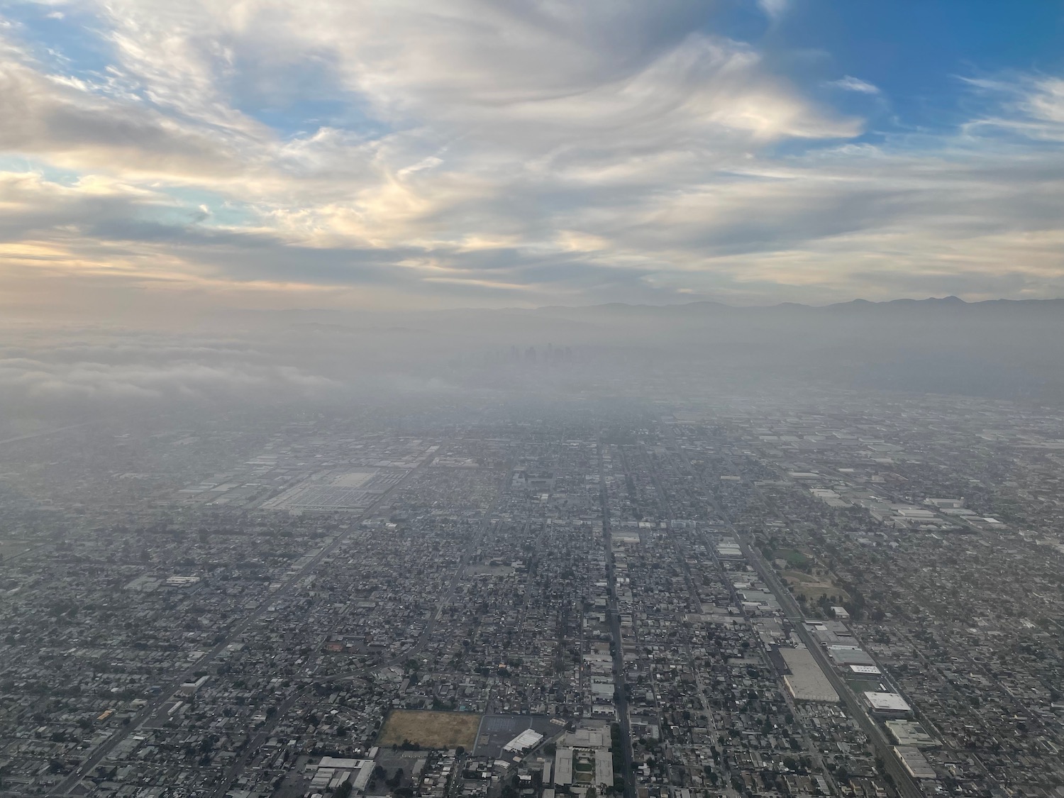 aerial view of a city with clouds in the sky