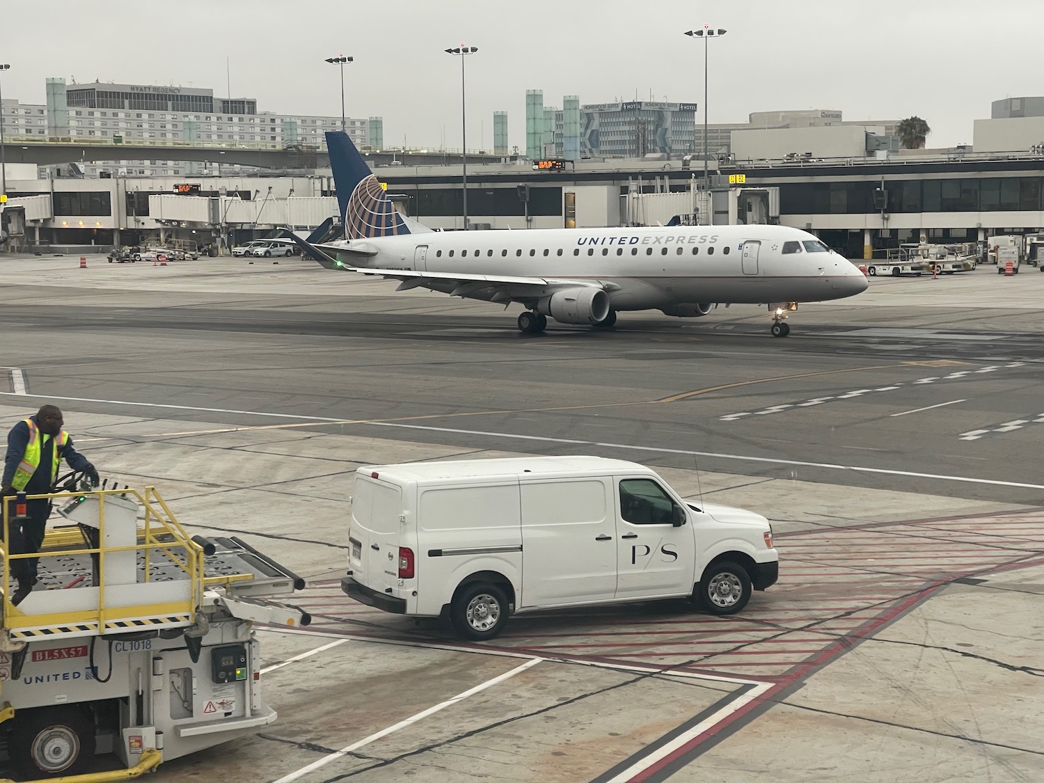 a white van and a plane on a runway