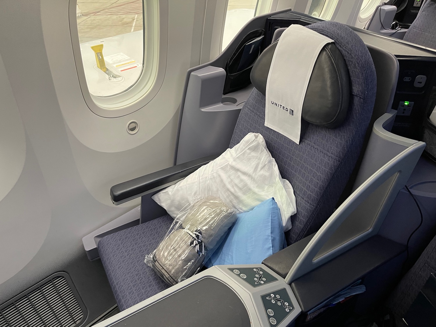 a seat with pillows and a bag on it
