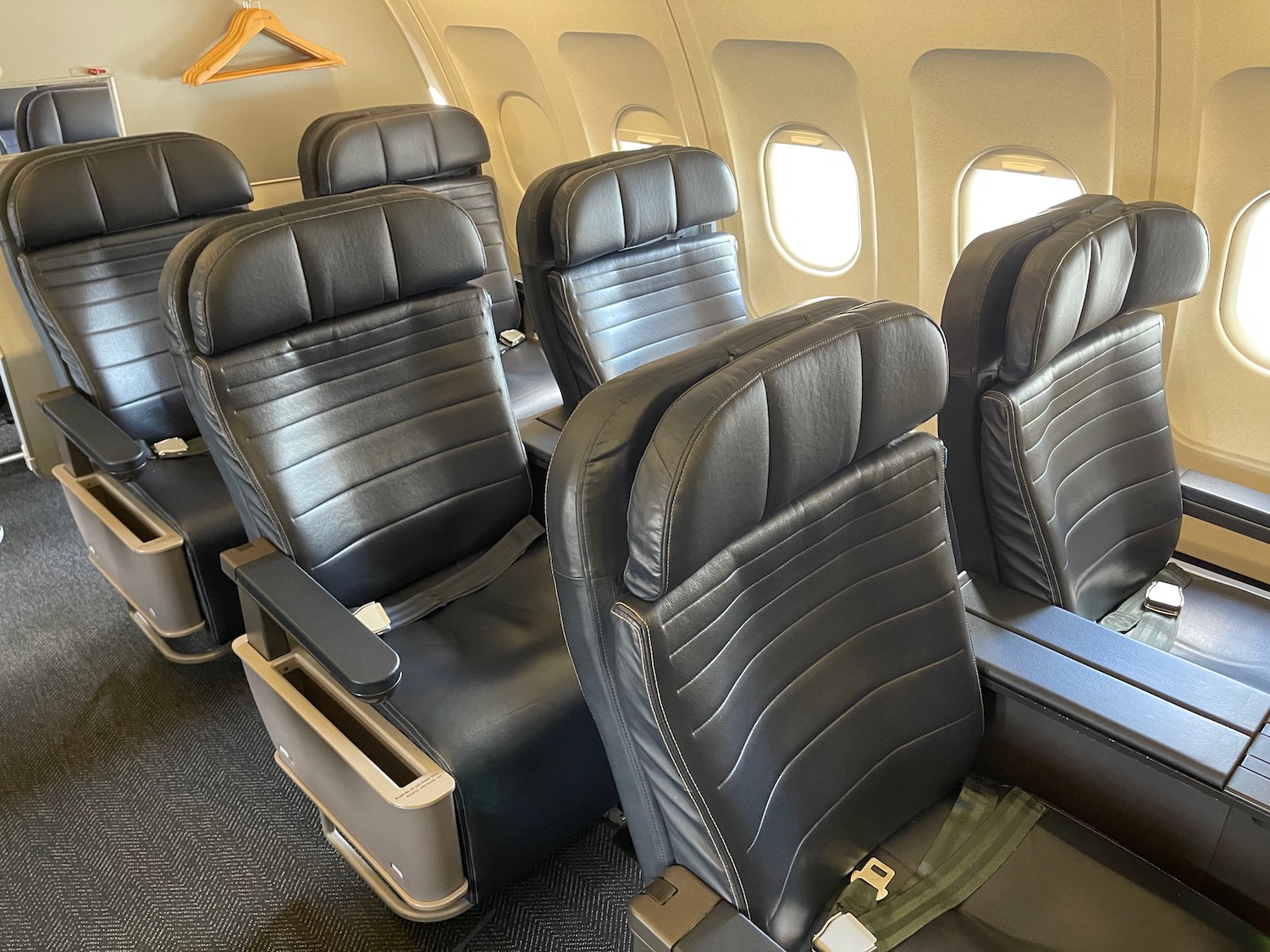 a row of black seats in an airplane