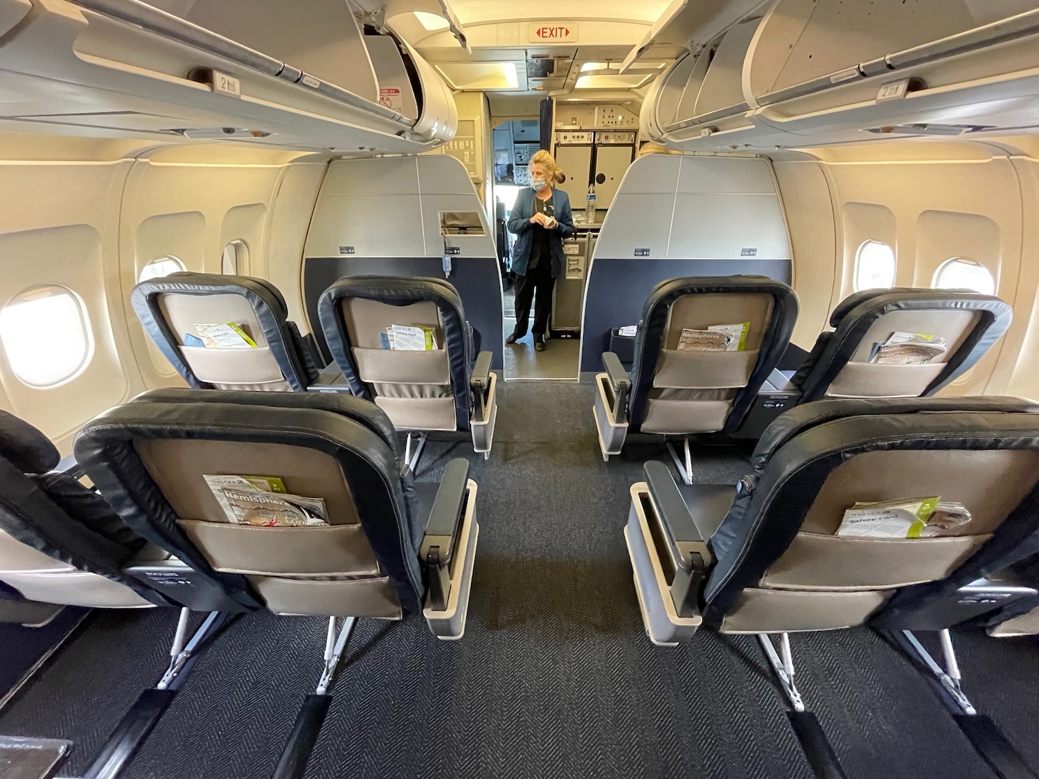 a woman standing in an airplane