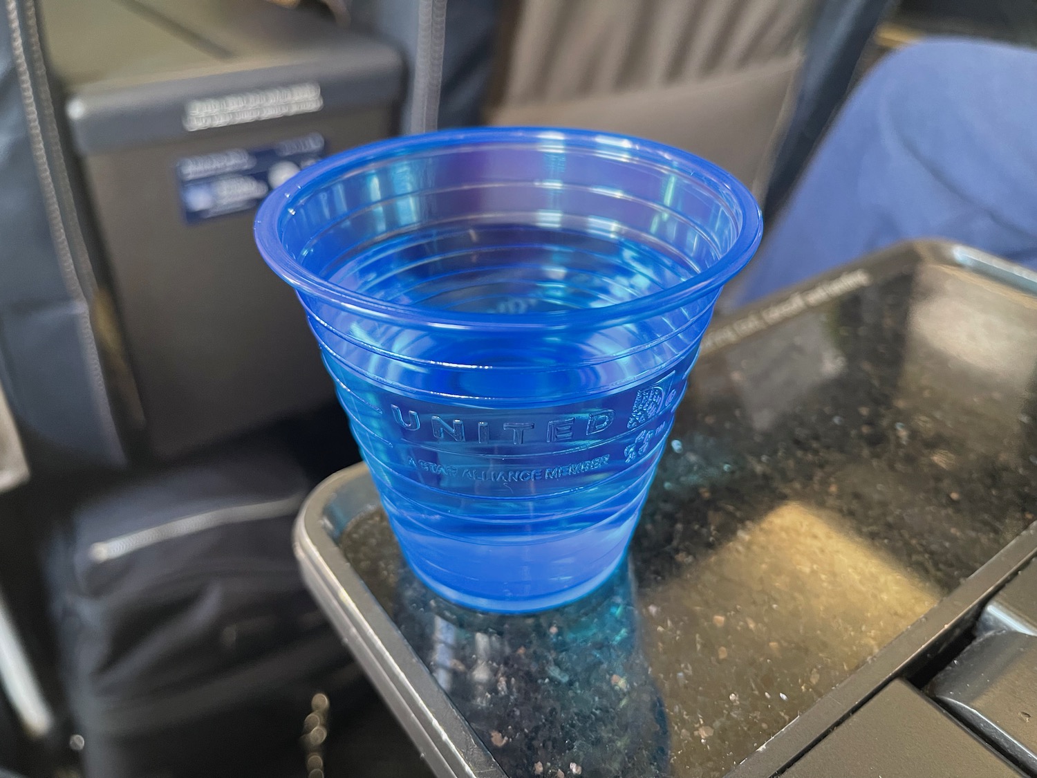 a blue plastic cup on a black surface