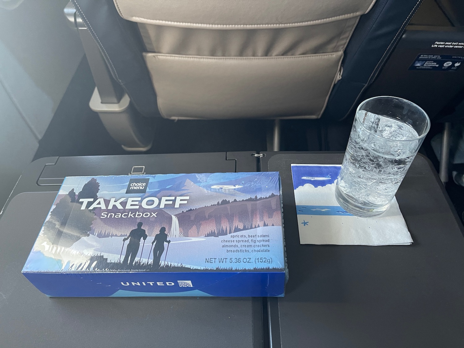 a glass of water next to a box of game