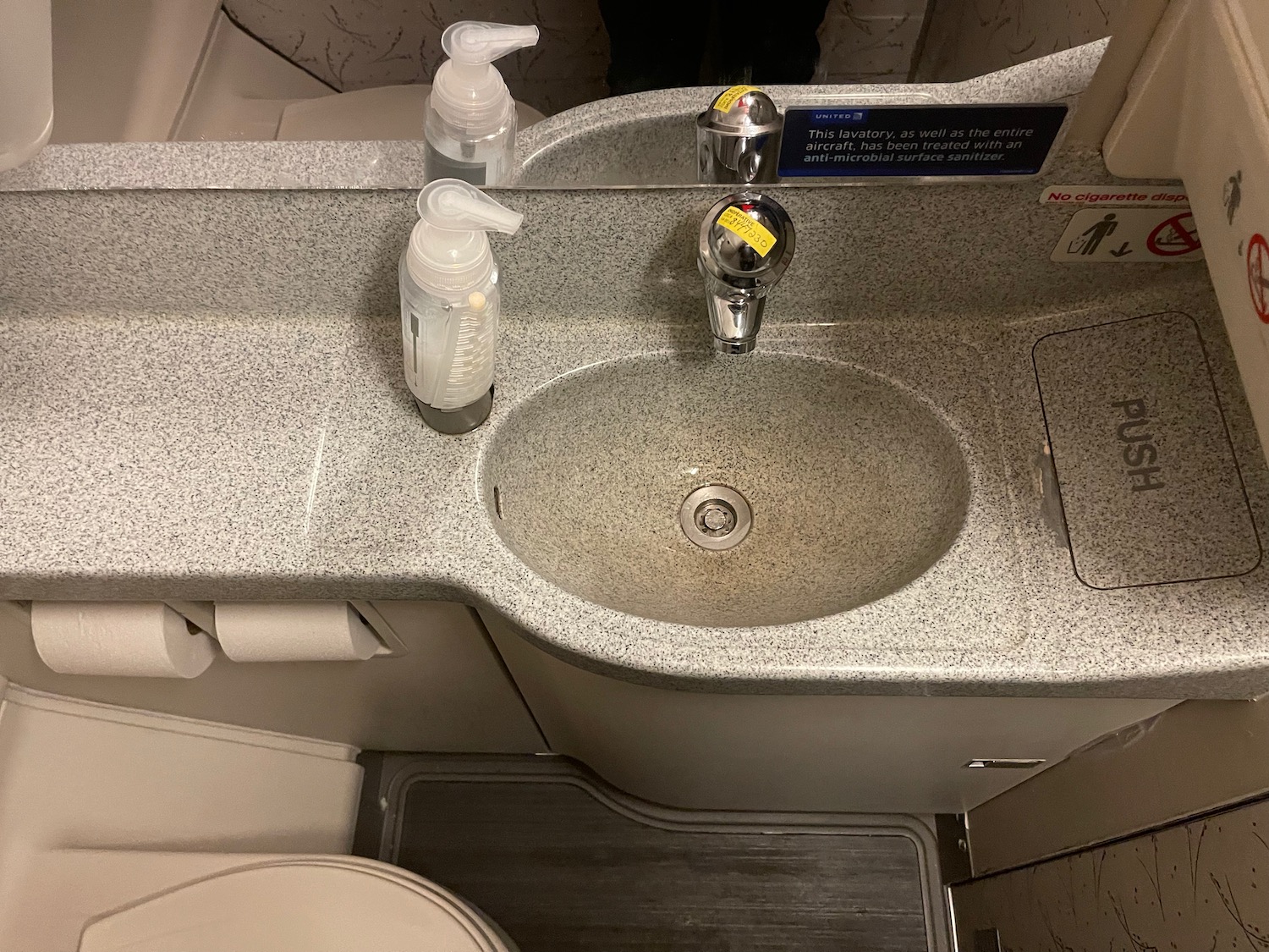 a sink with soap dispensers and soap dispensers on the counter