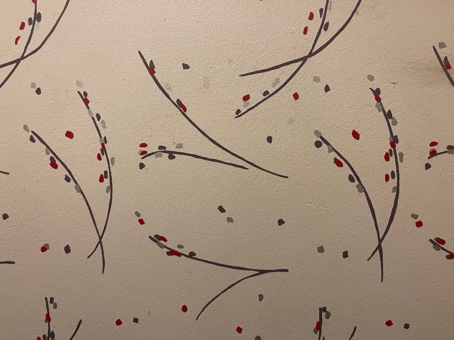 a wall with black and red flowers