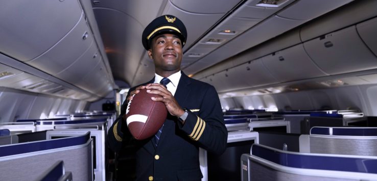 a man in uniform holding a football