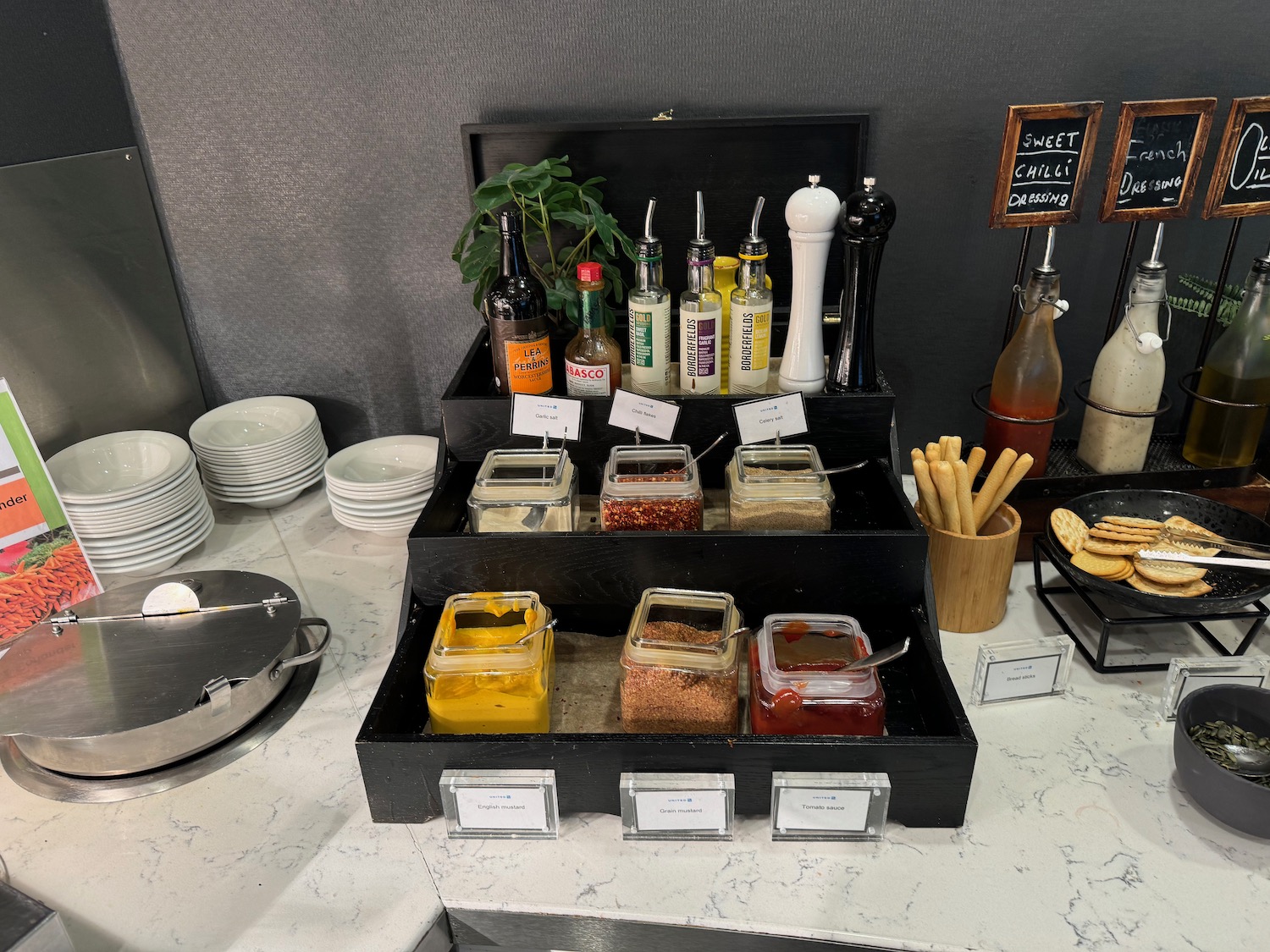 a counter with different condiments and sauces