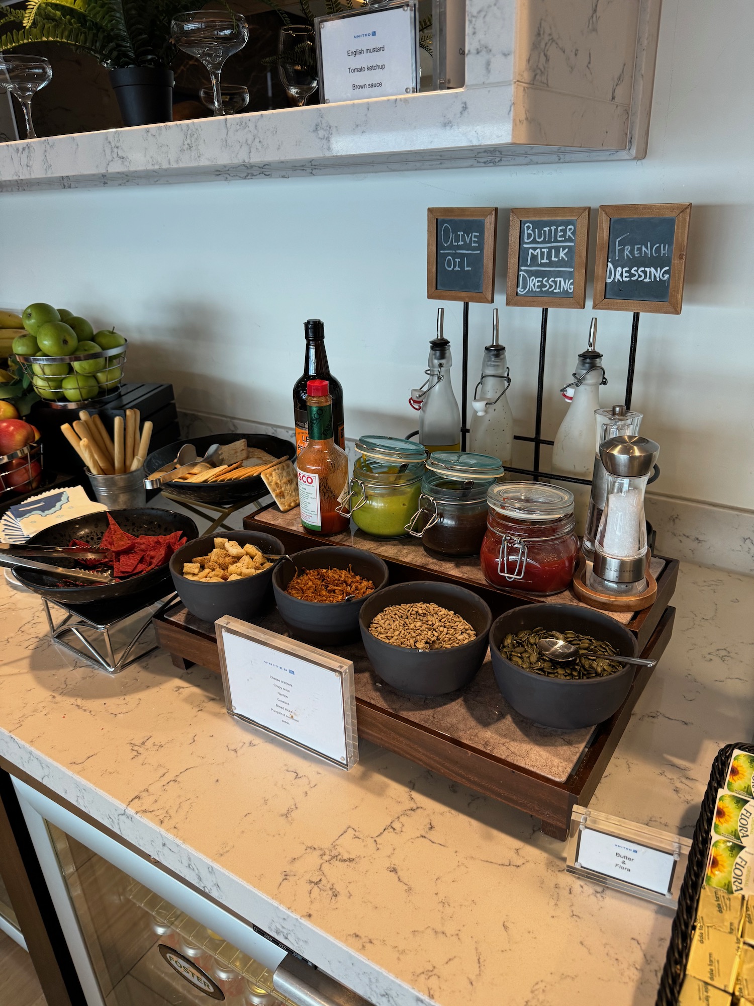 a counter with bowls of food and other condiments