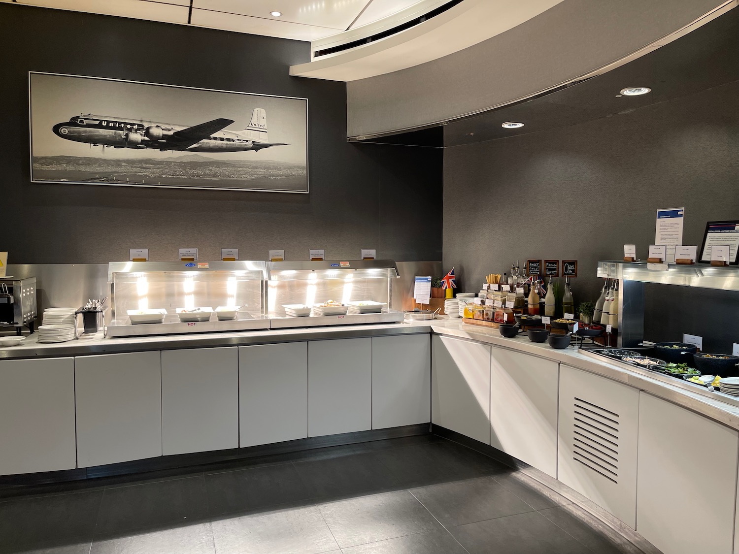 a kitchen with a large picture of an airplane