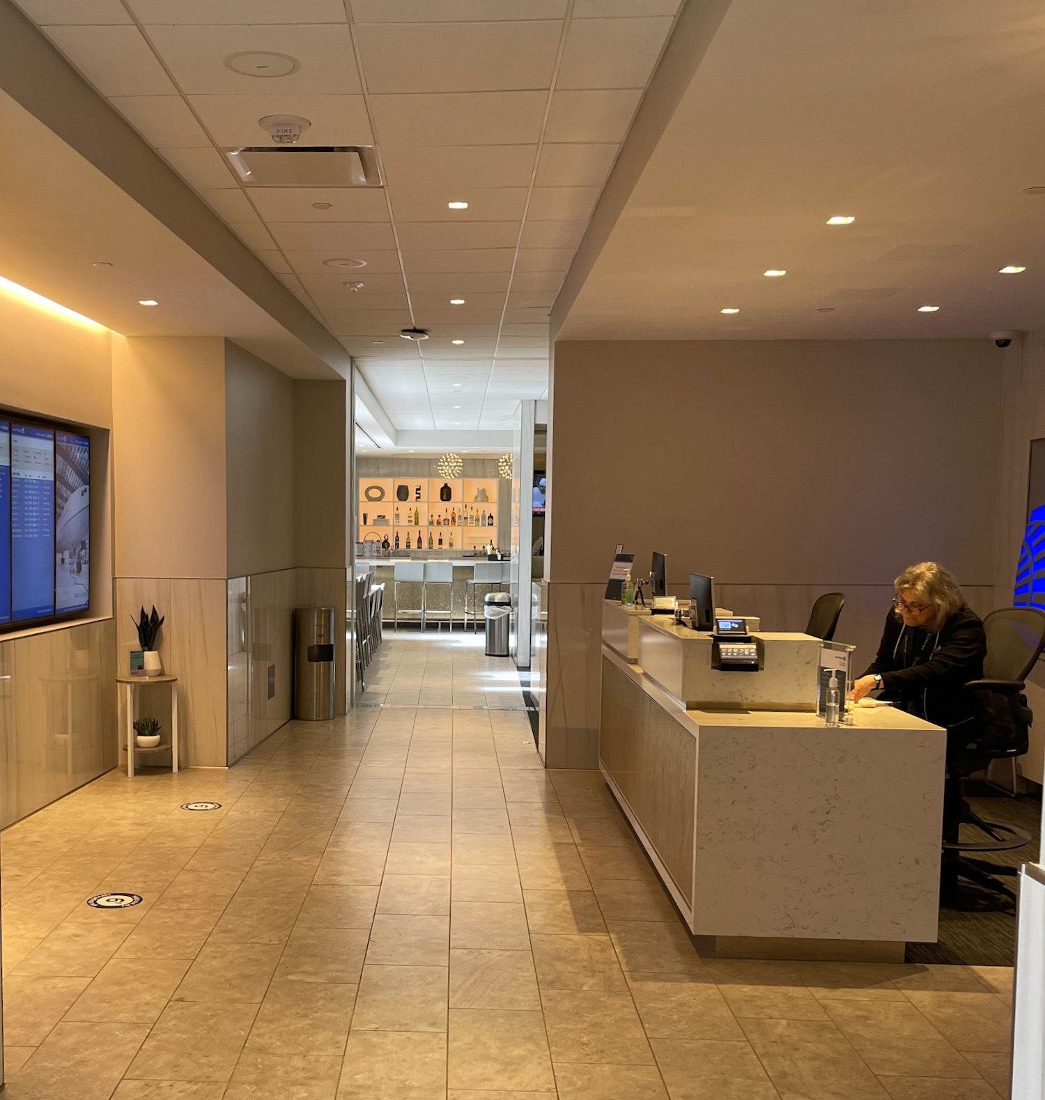 a woman sitting at a desk in a lobby