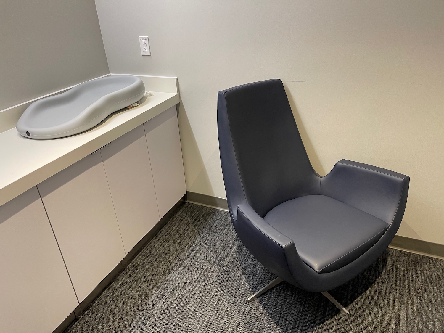 a chair next to a baby changing table