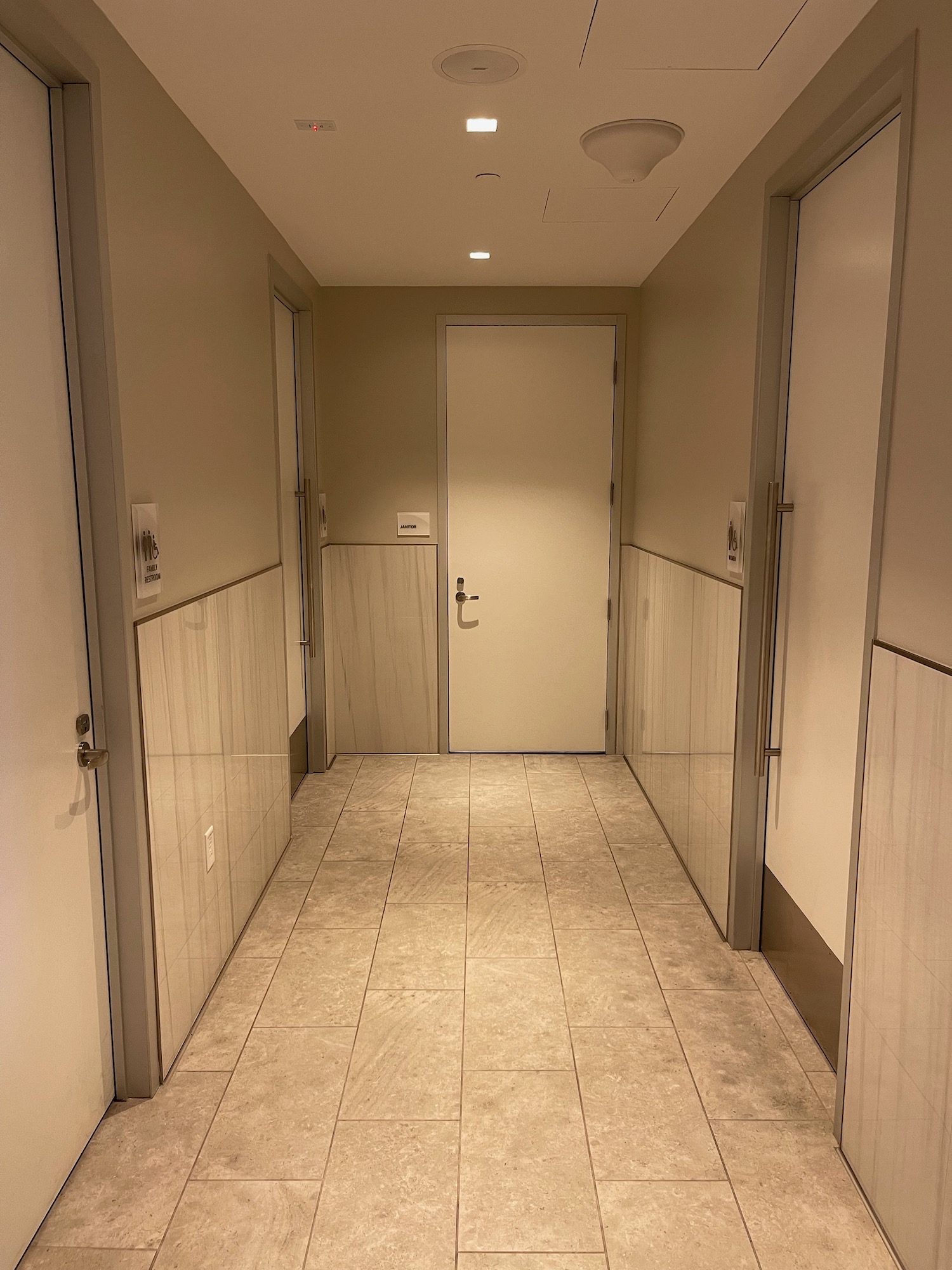 a hallway with doors and tile walls