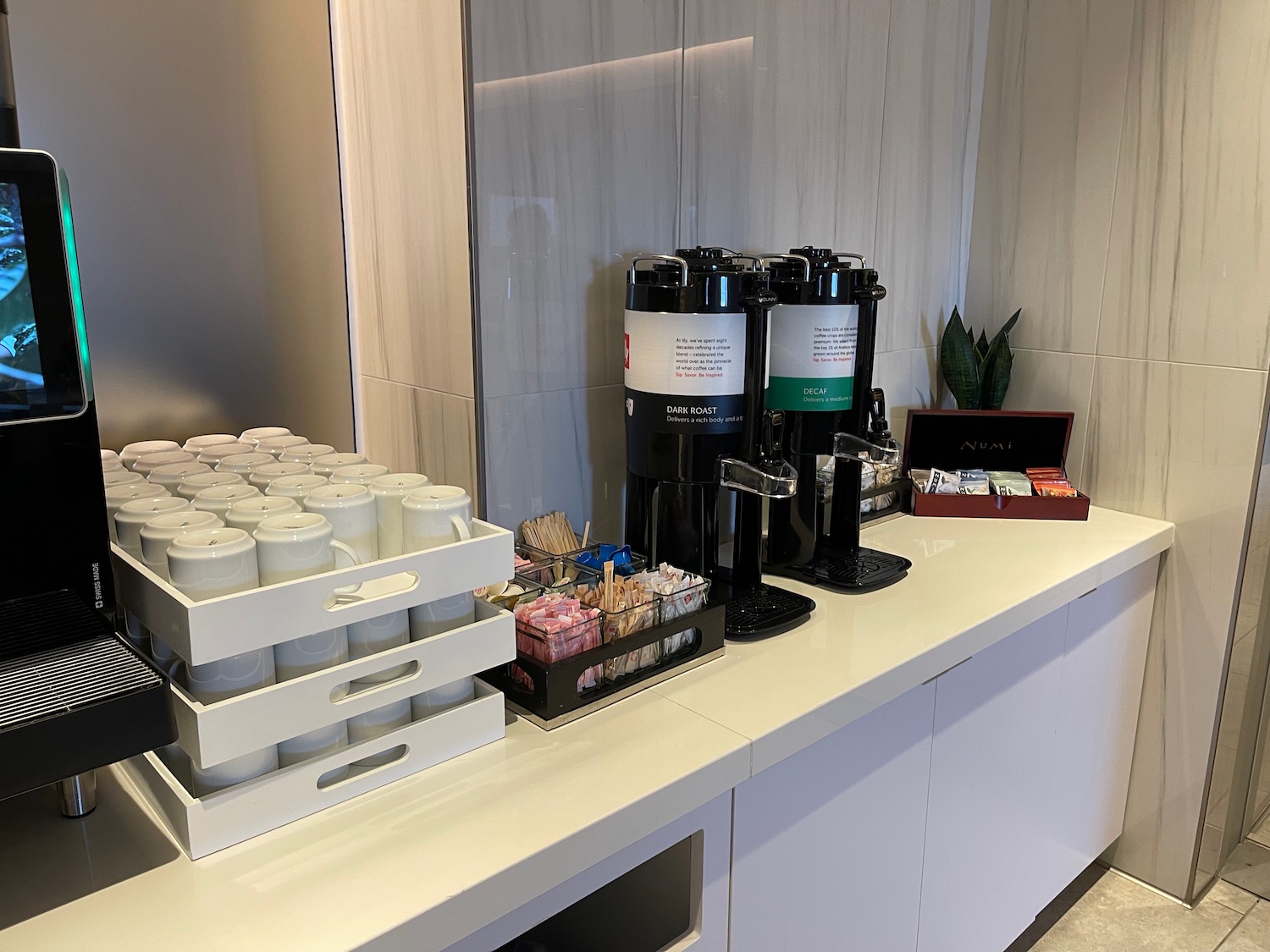 a coffee machine and coffee cups on a counter