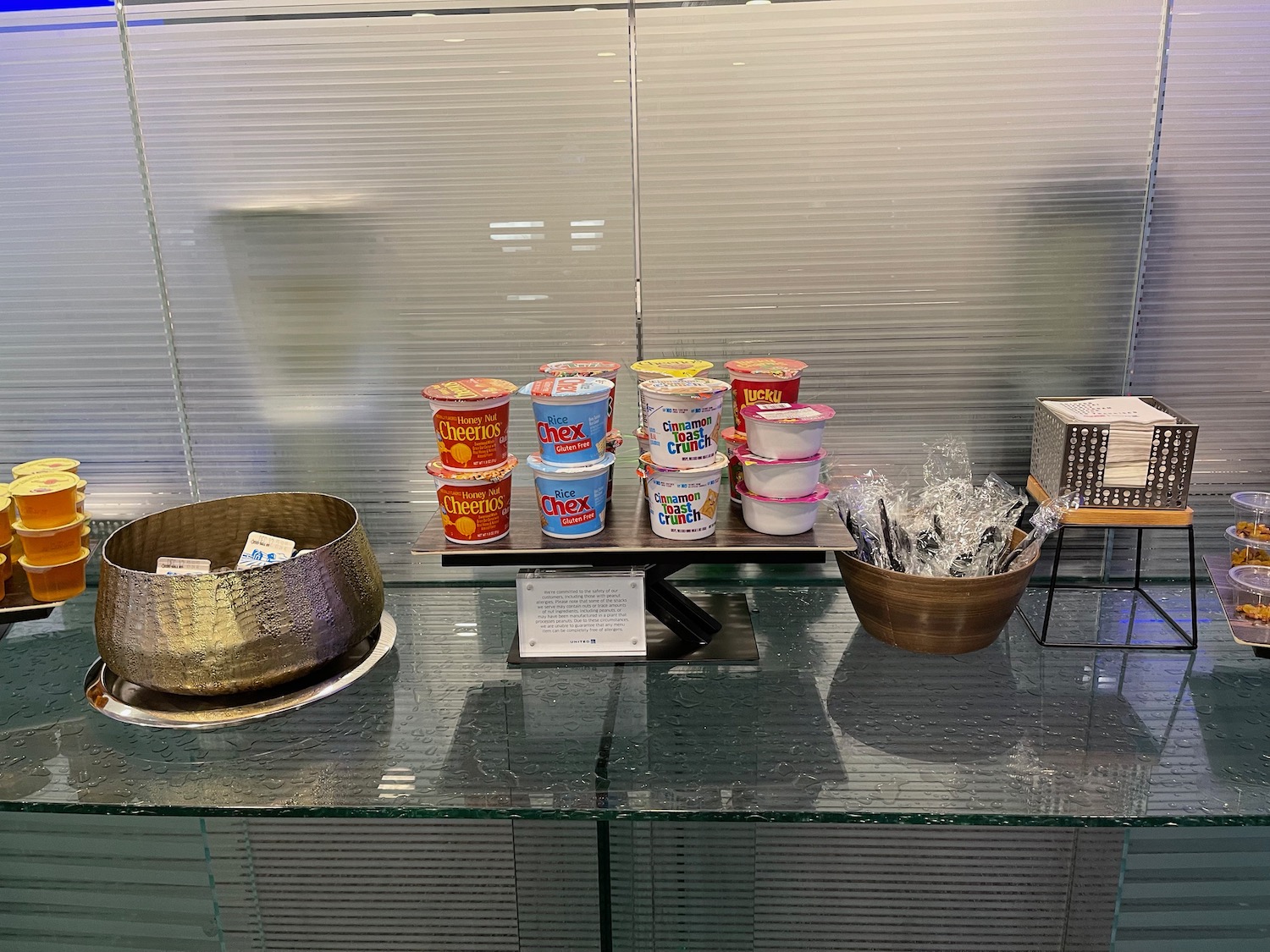 a group of cups of yogurt on a glass shelf