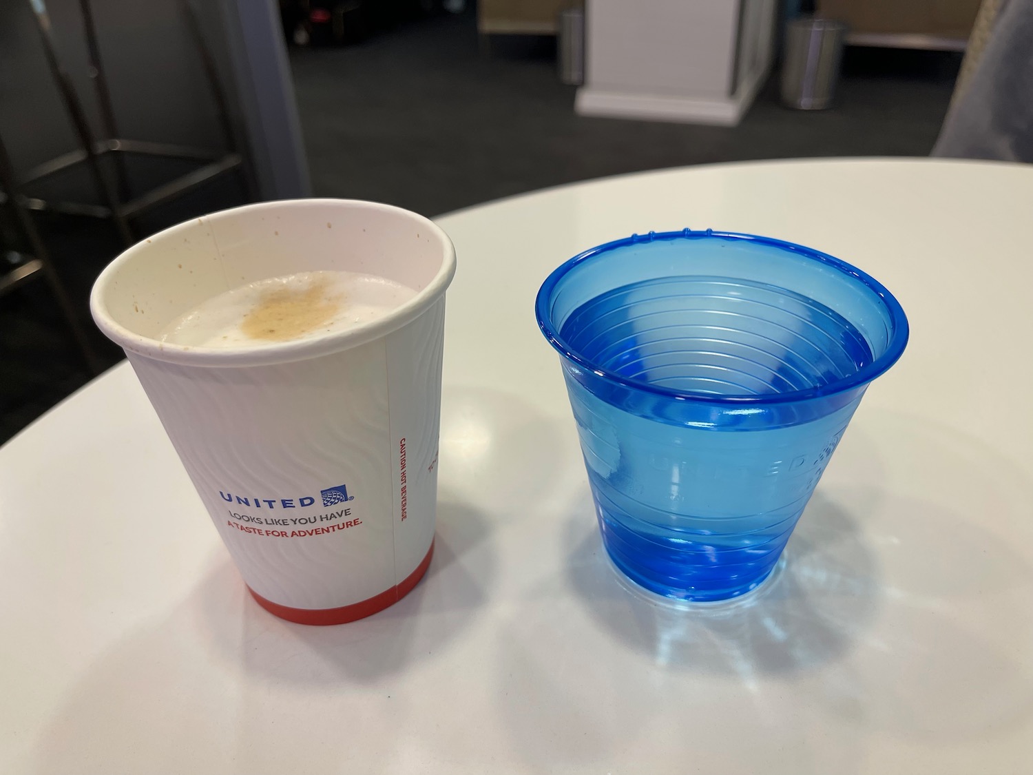 a cup and a cup of liquid on a table