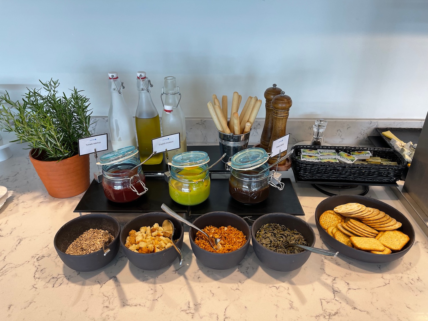 a table with bowls of food and bottles