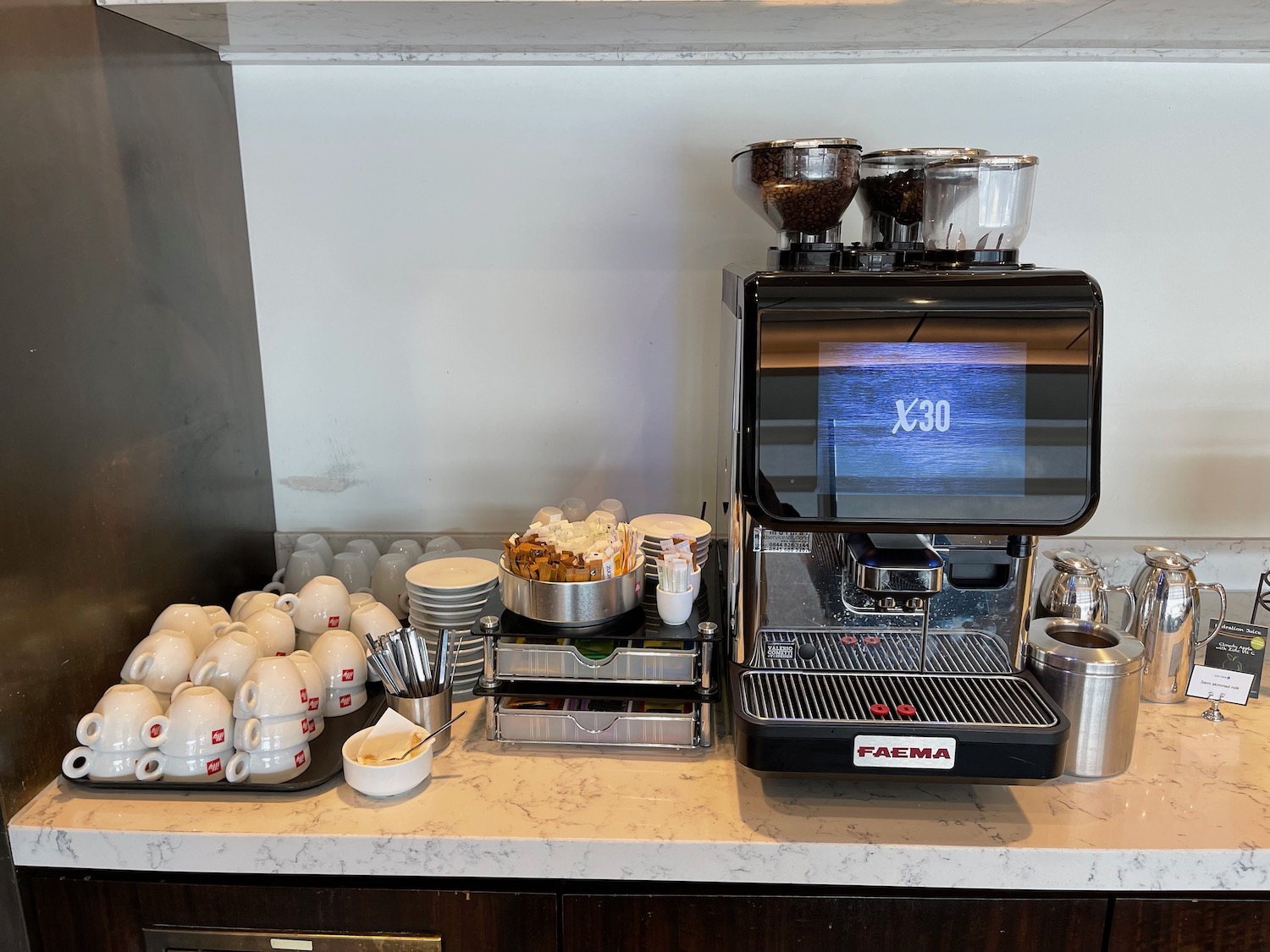 a coffee machine and cups on a counter