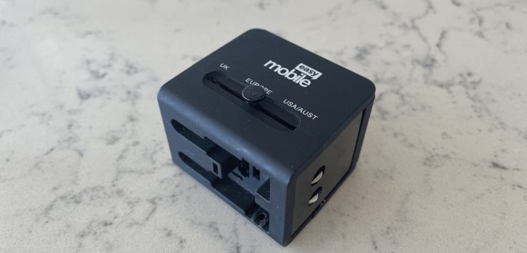 a black cube with a button on a marble surface