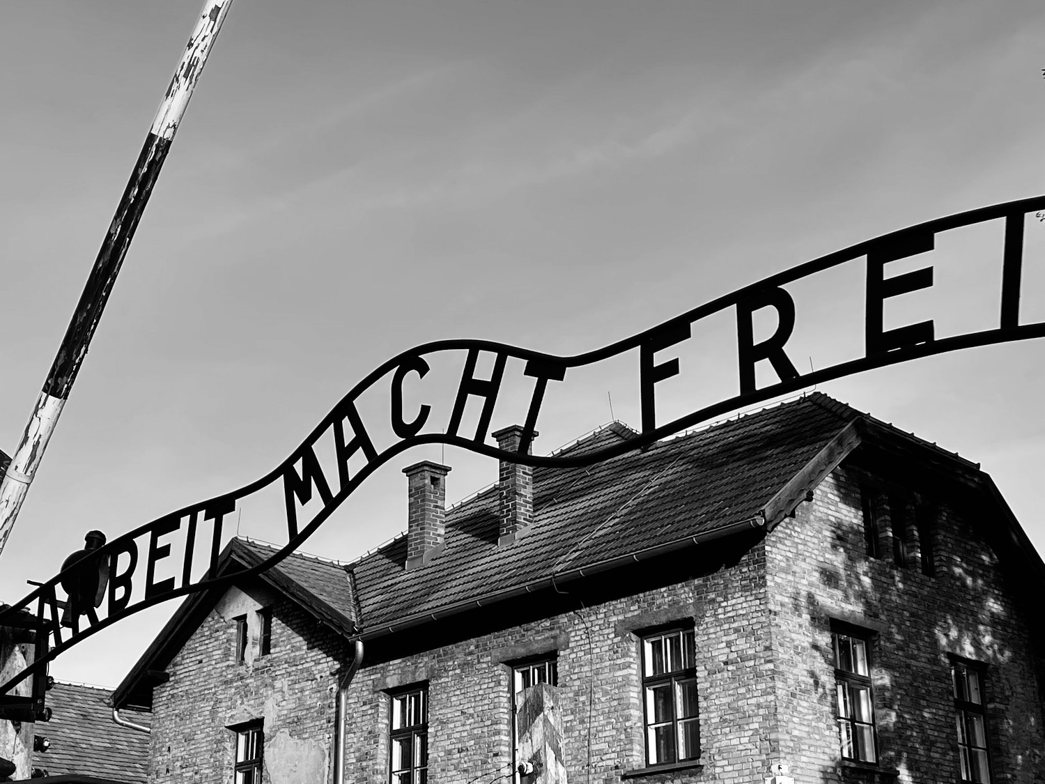 a sign with a flag in front of a brick building