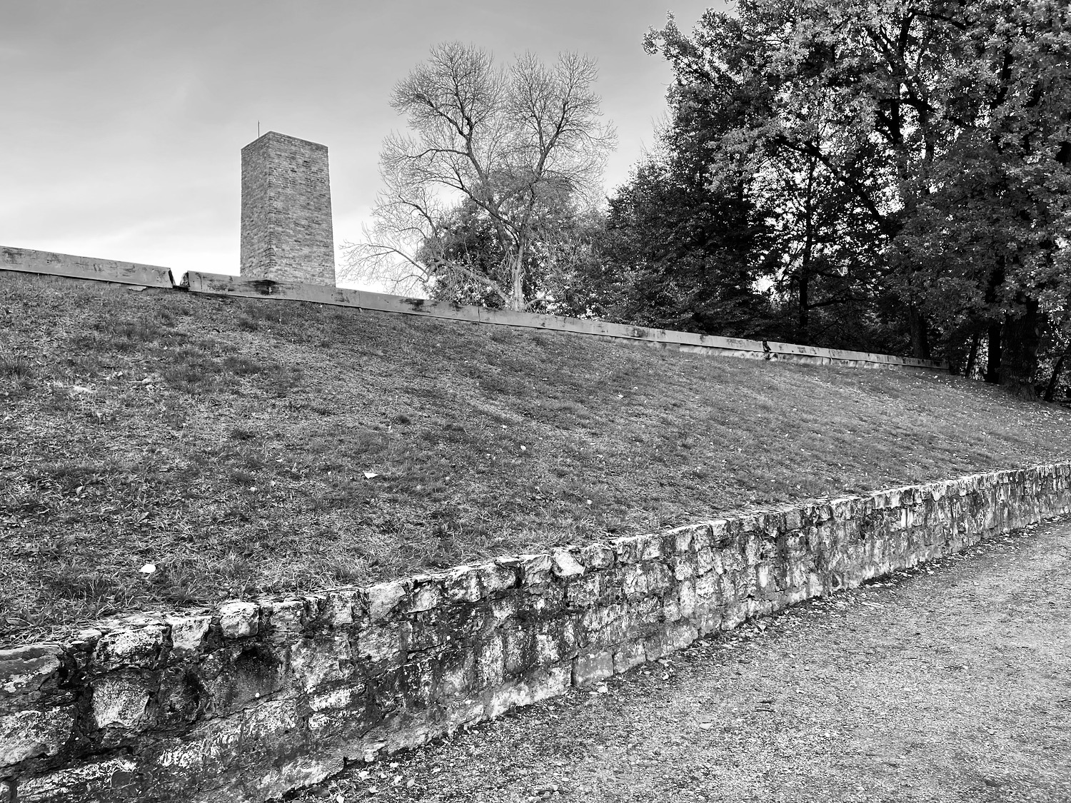 a stone wall with a tower in the background