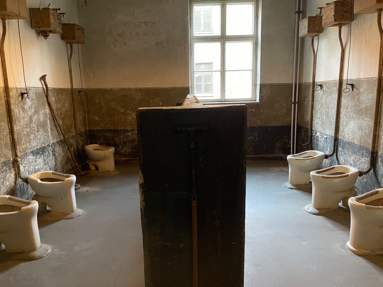 a room with toilets and a rectangular object