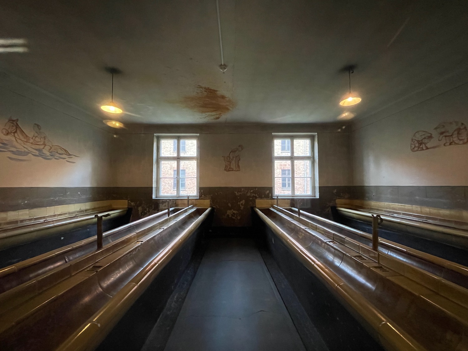 a room with metal railings and windows