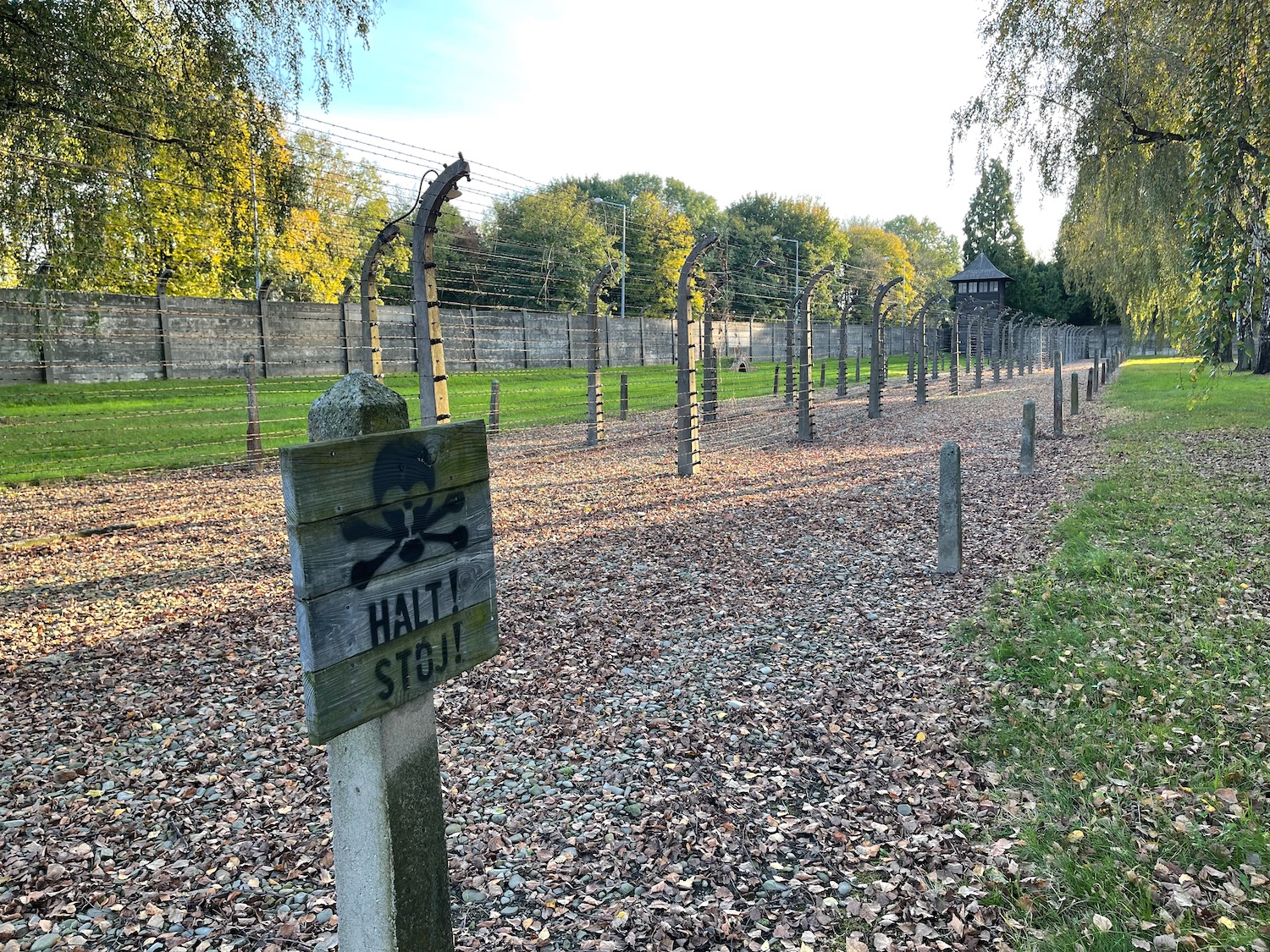 a fence with barbed wire and a sign