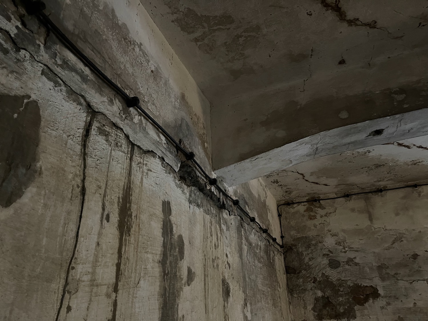 a concrete wall with a pipe running through it