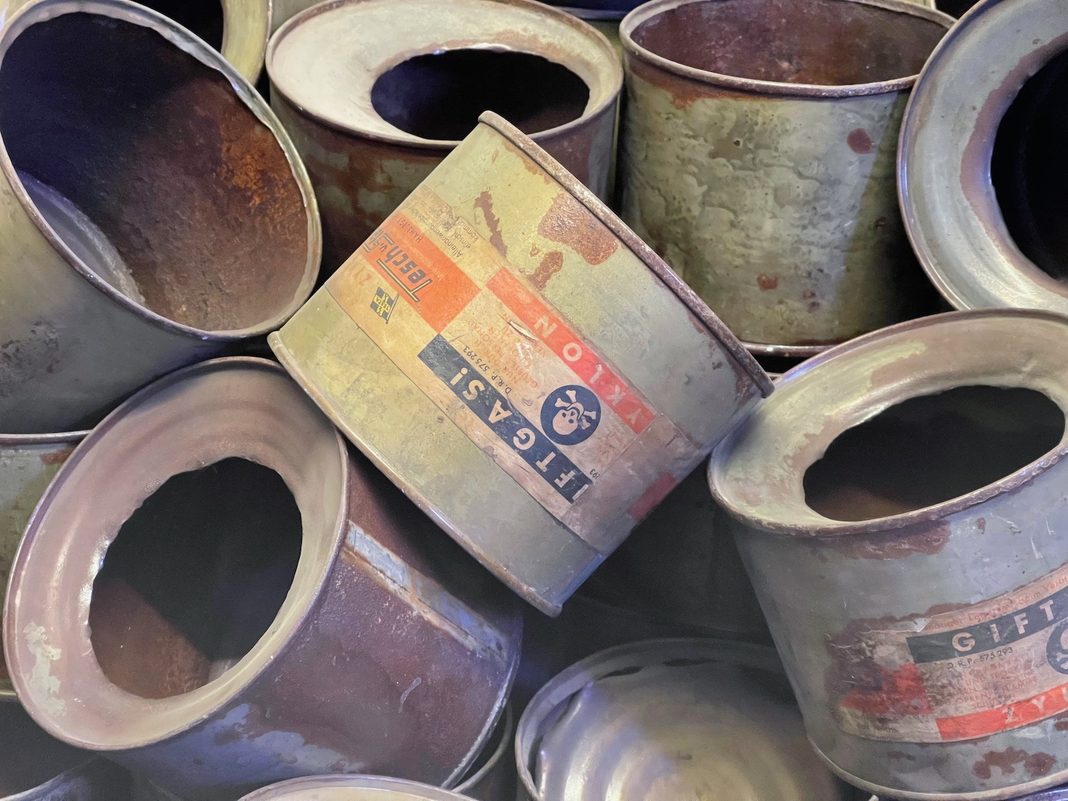 a group of rusty metal cans