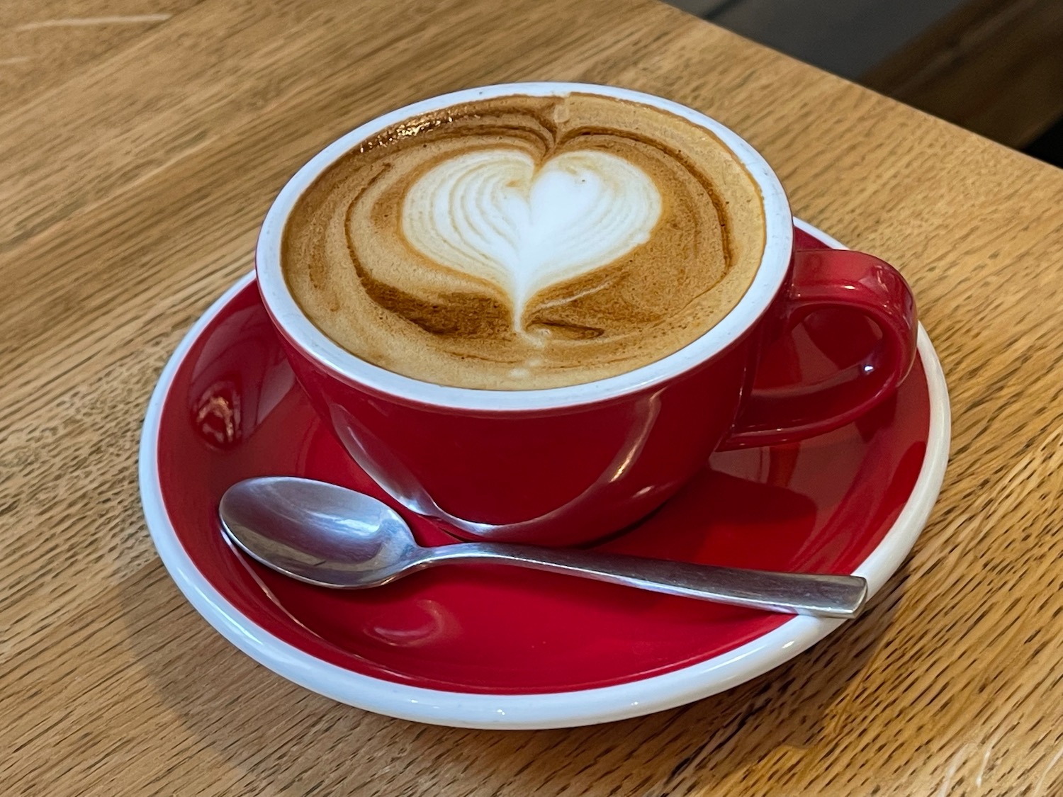 a cup of coffee with a heart shaped foam in it