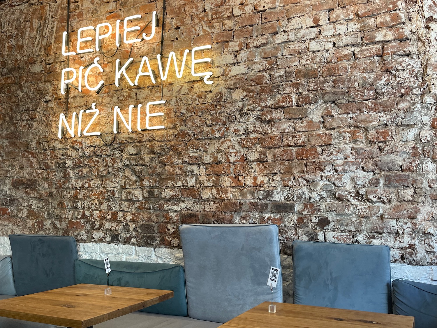 a brick wall with tables and chairs