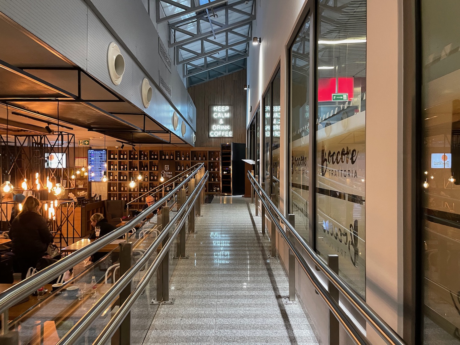 a walkway with a railing and a glass wall